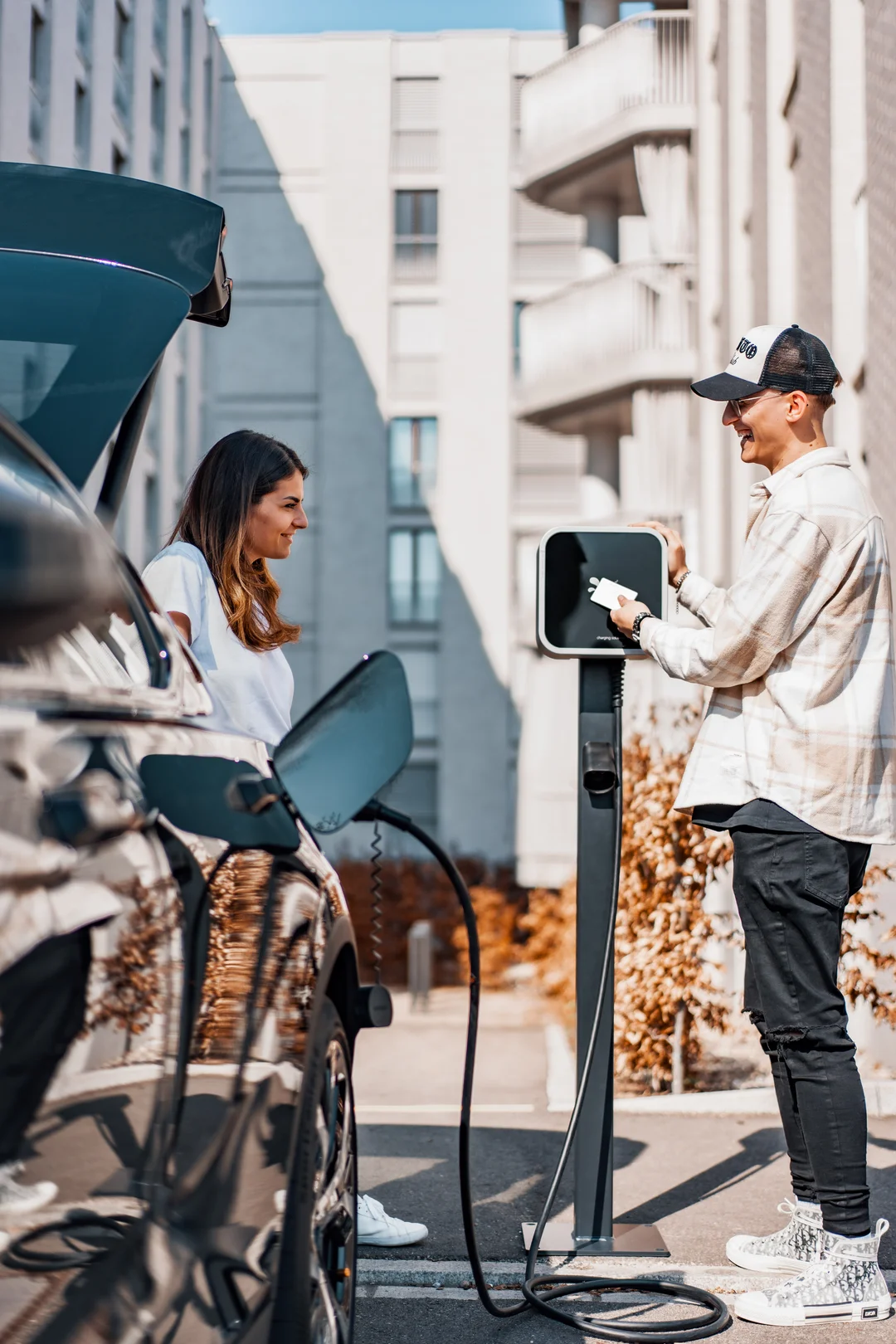 a man and a women are charging their cars